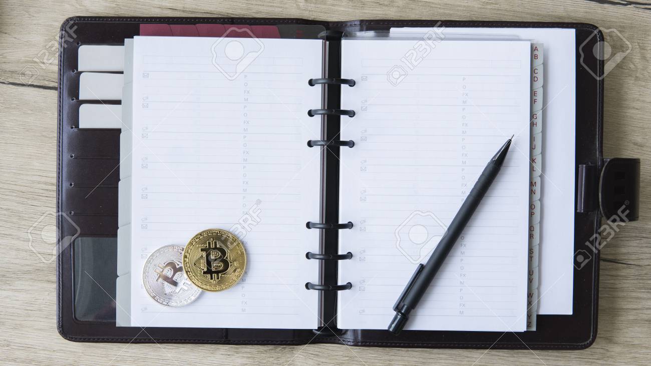 Notebook Of Bitcoin Miner Gold And Silver Bitcoin And Pen On - 